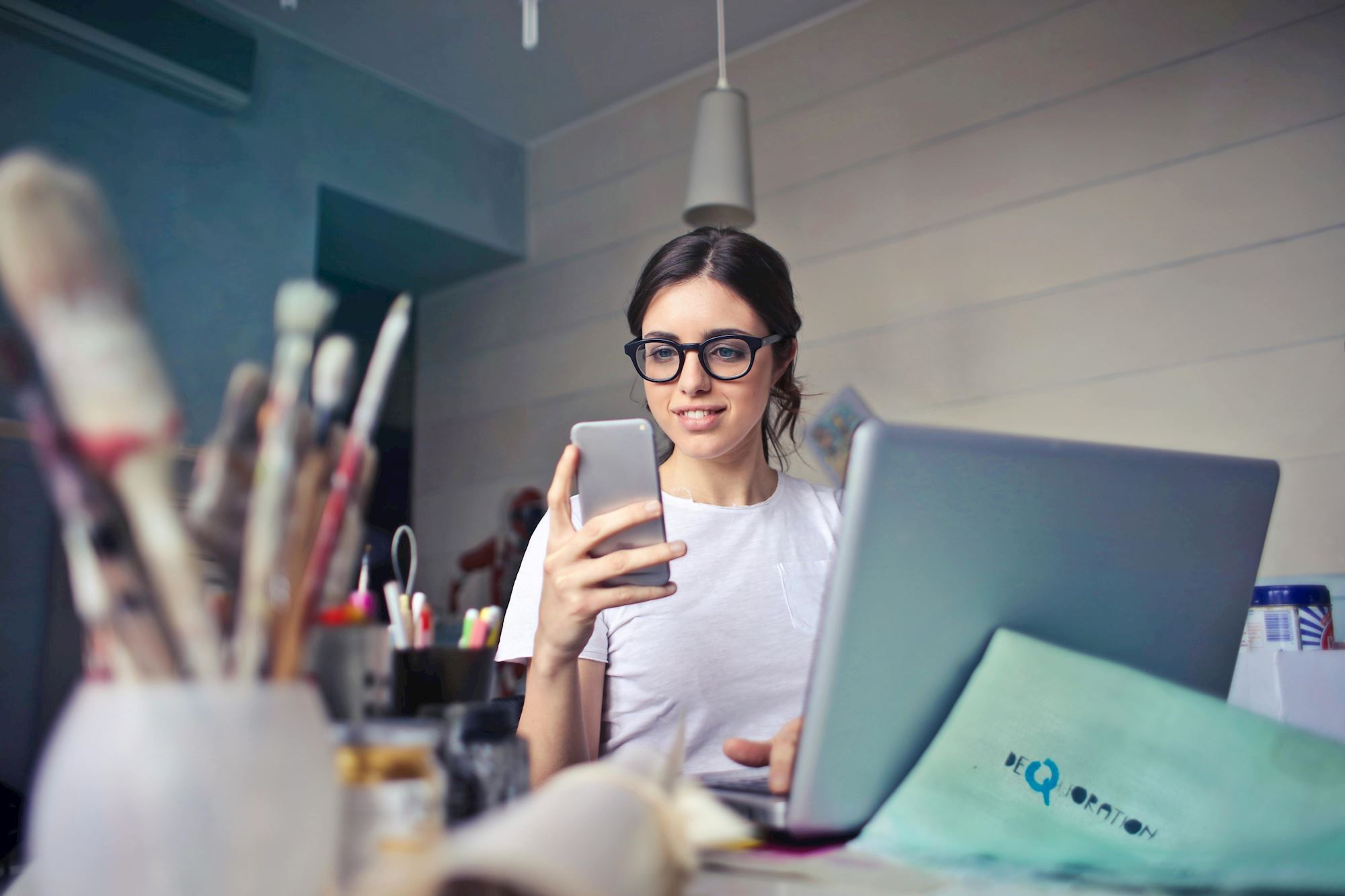 Girl using both phone and laptop